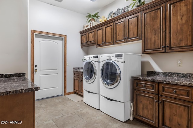 washroom featuring light tile patterned floors, cabinet space, and washer and dryer
