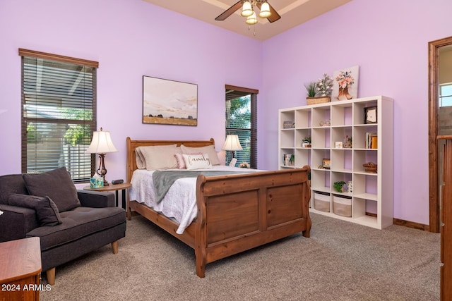 bedroom featuring carpet floors, a ceiling fan, and multiple windows