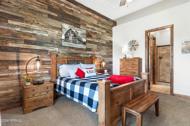 carpeted bedroom featuring wooden walls and ceiling fan