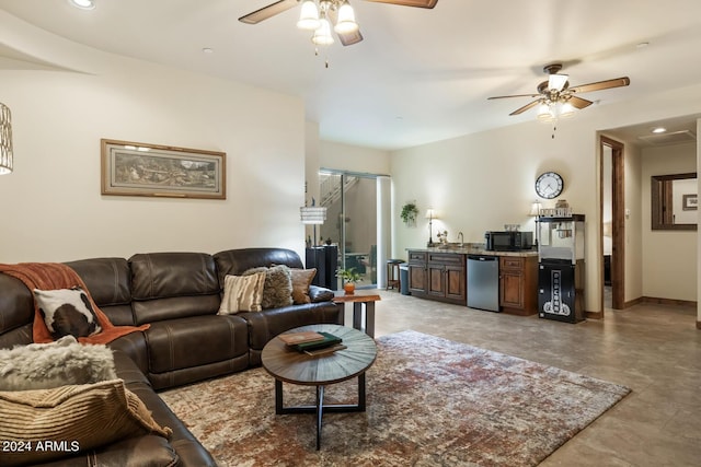 living room with baseboards, a ceiling fan, and recessed lighting
