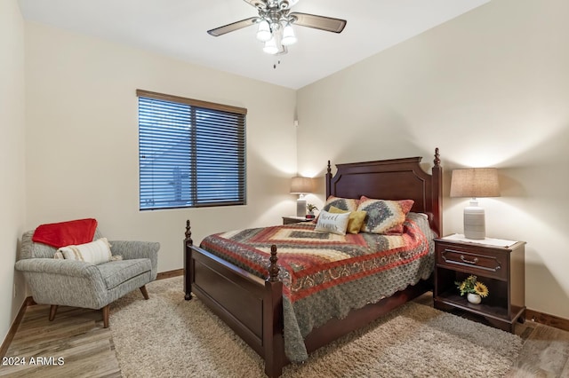 bedroom featuring baseboards, ceiling fan, and wood finished floors