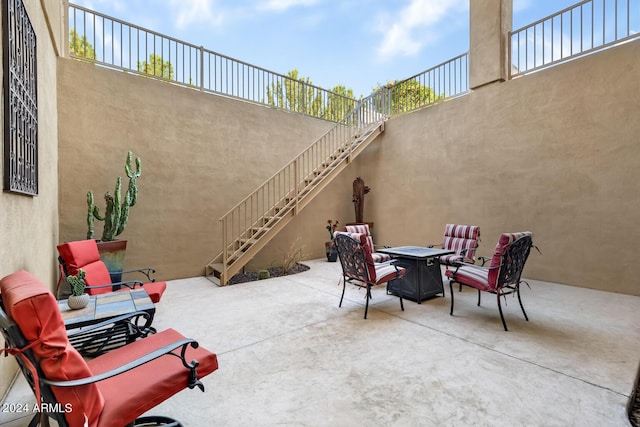 view of patio / terrace featuring a fire pit and stairway
