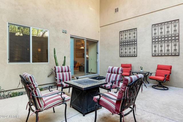view of patio with visible vents and an outdoor living space with a fire pit