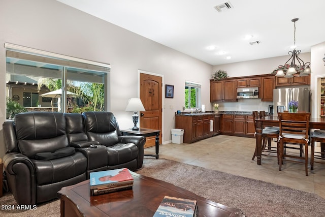 living room featuring baseboards, visible vents, and light tile patterned floors