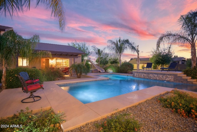outdoor pool featuring a patio and a water slide