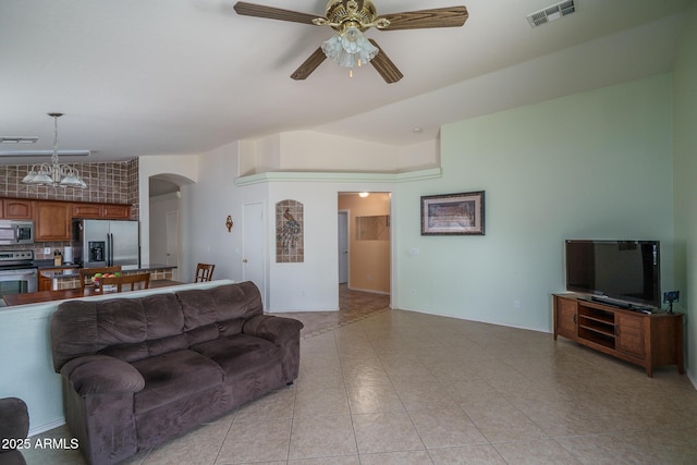 10618 W Pima St, Tolleson, AZ 85353 - living room with arched walkways, ceiling fan, vaulted ceiling, and light tile patterned floors
