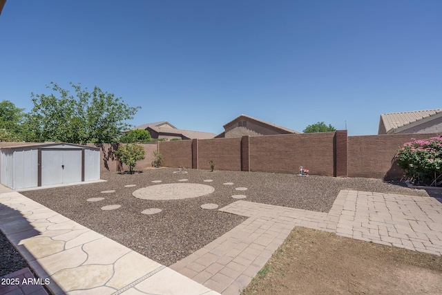 10618 W Pima St, Tolleson, AZ 85353 - fenced backyard featuring a storage unit and a patio area