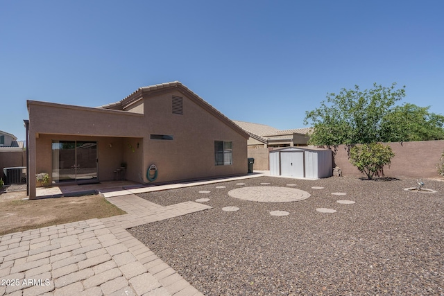 10618 W Pima St, Tolleson, AZ 85353 - rear view of property featuring a shed, stucco siding, a patio, and a tile roof