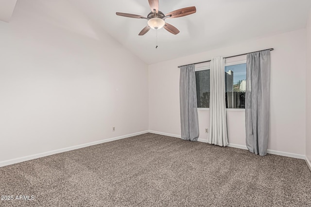 carpeted spare room featuring baseboards, ceiling fan, and vaulted ceiling