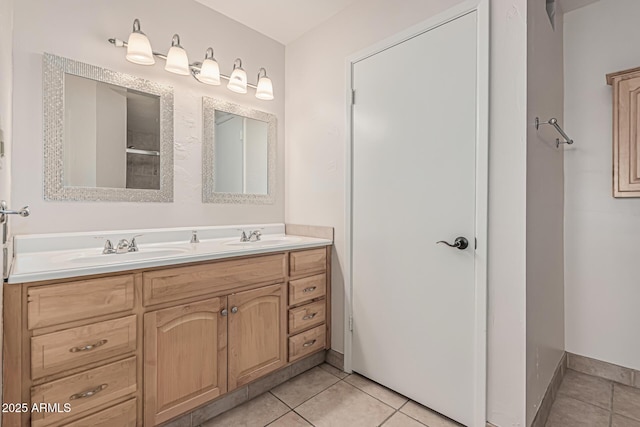 bathroom with tile patterned floors, double vanity, and a sink