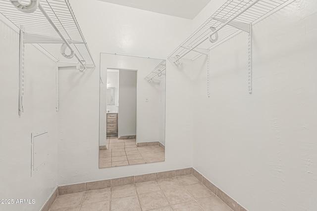walk in closet with tile patterned flooring