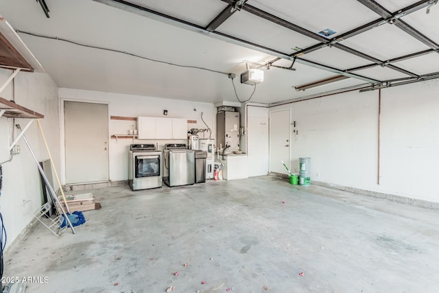 garage with a garage door opener, separate washer and dryer, and water heater