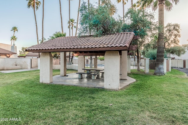 exterior space featuring fence, a gazebo, and a patio area