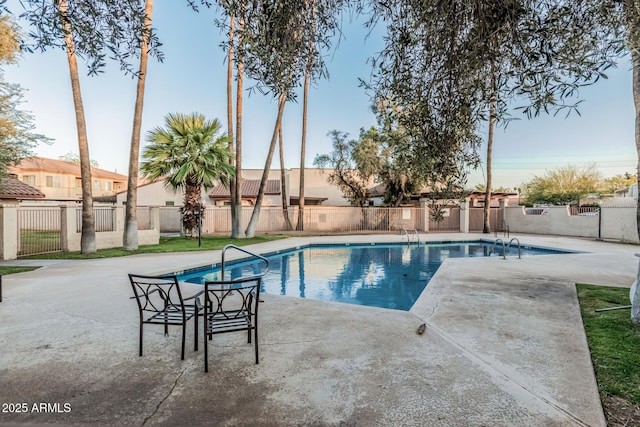 view of pool with a patio, a fenced in pool, and fence