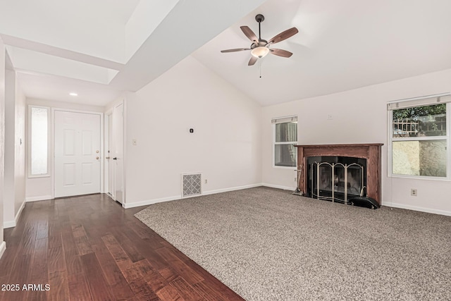 unfurnished living room with visible vents, baseboards, dark wood finished floors, vaulted ceiling, and a ceiling fan