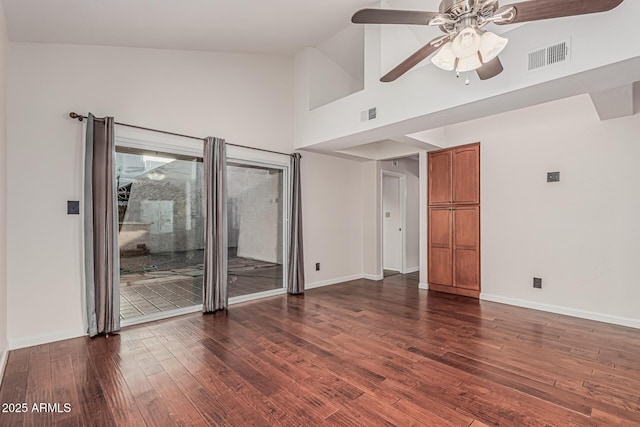 unfurnished room featuring dark wood-style floors, visible vents, ceiling fan, and high vaulted ceiling