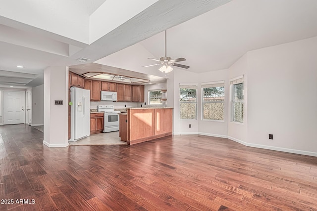 unfurnished living room featuring wood finished floors, a ceiling fan, and baseboards