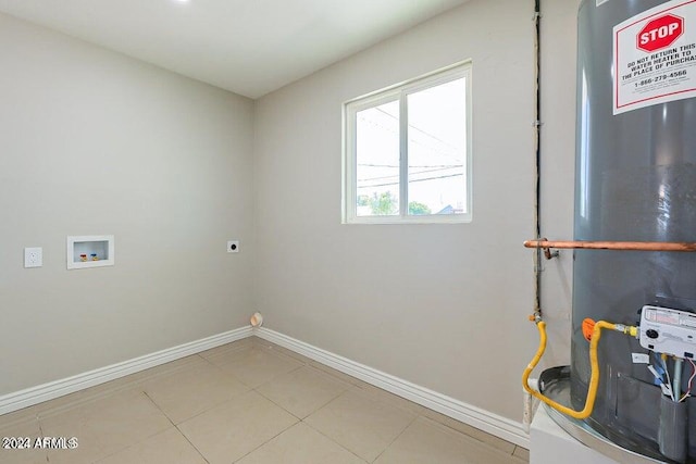 washroom featuring gas water heater, washer hookup, light tile patterned floors, and hookup for an electric dryer