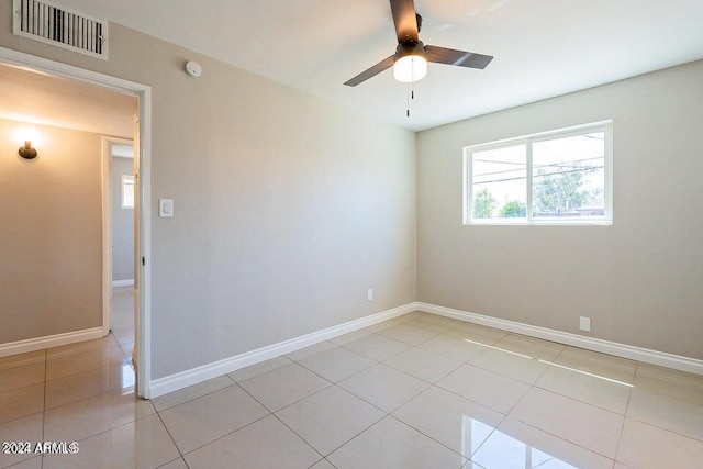 unfurnished room featuring light tile patterned flooring and ceiling fan