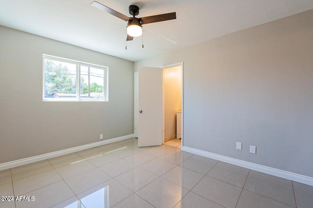 empty room featuring ceiling fan and light tile patterned flooring