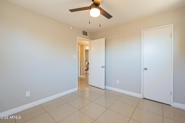 unfurnished bedroom featuring light tile patterned floors and ceiling fan