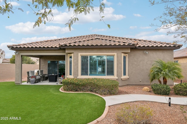 rear view of property featuring a patio and a lawn