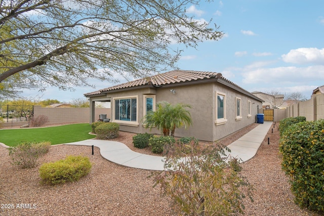 view of side of home with a yard