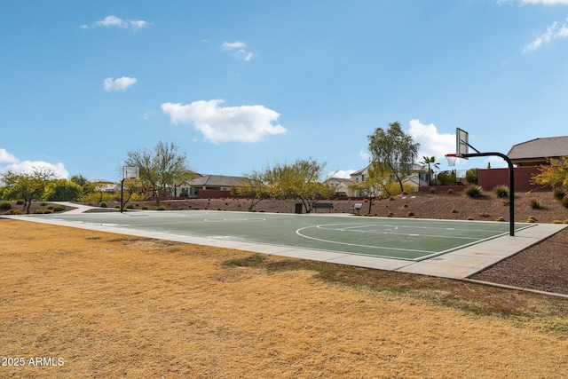 view of sport court with a lawn