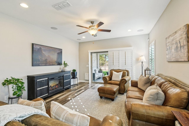 living room featuring hardwood / wood-style floors and ceiling fan