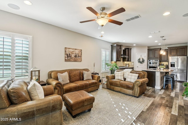 living room with hardwood / wood-style floors and ceiling fan