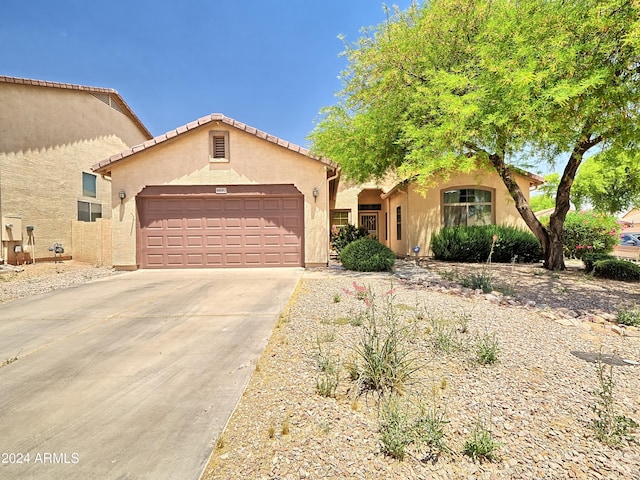 mediterranean / spanish-style home with a garage