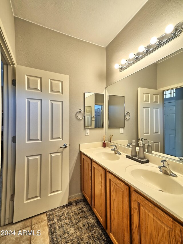 bathroom featuring tile patterned flooring and vanity