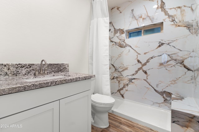 bathroom with vanity, wood-type flooring, toilet, and walk in shower