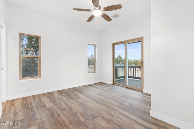 unfurnished room with hardwood / wood-style flooring and ceiling fan