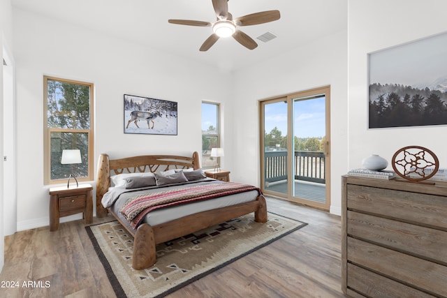 bedroom featuring hardwood / wood-style flooring, access to exterior, and ceiling fan