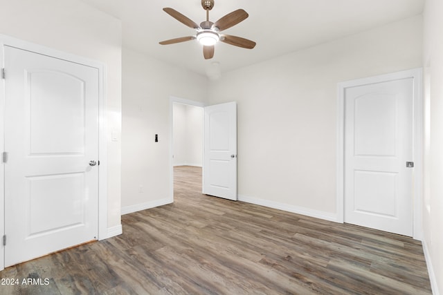 unfurnished bedroom featuring dark wood-type flooring and ceiling fan