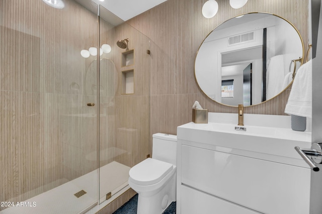 bathroom featuring an enclosed shower, vanity, and toilet