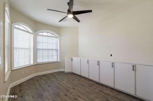 unfurnished room with ceiling fan and dark hardwood / wood-style flooring