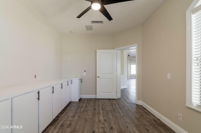 laundry area featuring ceiling fan and dark hardwood / wood-style flooring