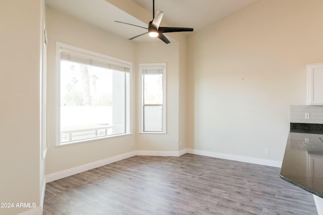 unfurnished dining area featuring light wood-type flooring and ceiling fan