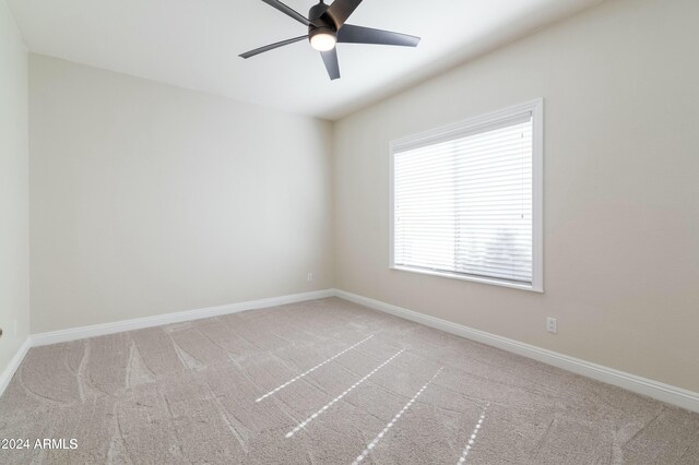 empty room with light carpet and ceiling fan