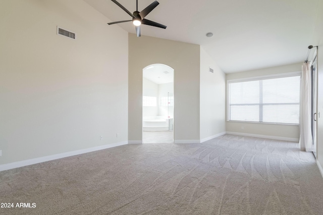 carpeted spare room featuring ceiling fan and lofted ceiling