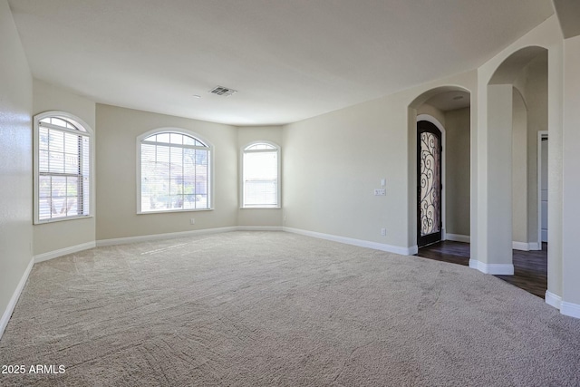 unfurnished room featuring dark carpet