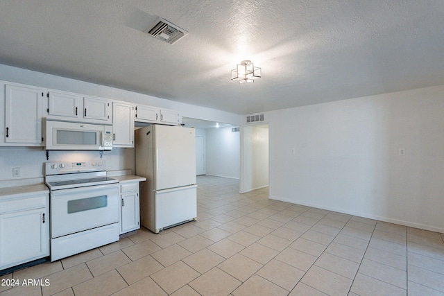 3115 N 55th Ave, Phoenix, AZ 85031 - kitchen with white appliances, light countertops, white cabinets, light tile patterned floors, and a textured ceiling
