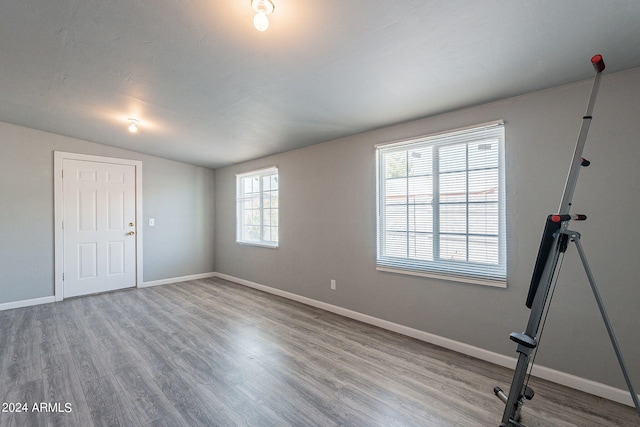 3115 N 55th Ave, Phoenix, AZ 85031 - unfurnished room featuring wood finished floors and vaulted ceiling