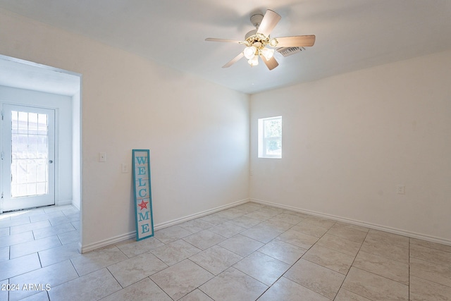 3115 N 55th Ave, Phoenix, AZ 85031 - unfurnished room featuring healthy amount of natural light, ceiling fan, and light tile patterned flooring