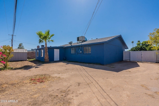 3115 N 55th Ave, Phoenix, AZ 85031 - back of property featuring a gate and a storage unit