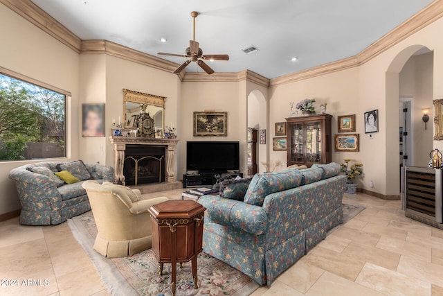 living room featuring ceiling fan and crown molding