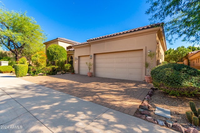 mediterranean / spanish home with a garage