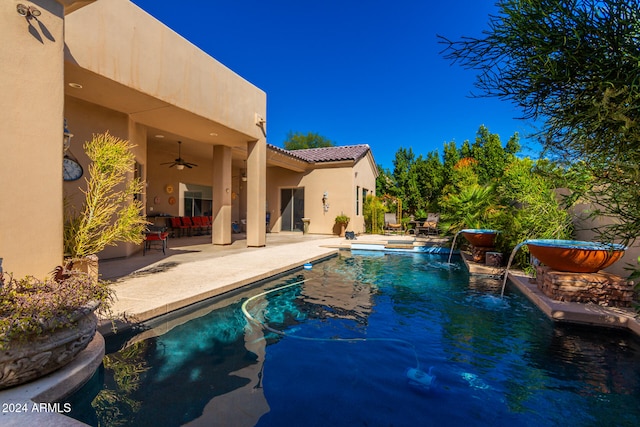 view of swimming pool featuring ceiling fan, a patio, and pool water feature